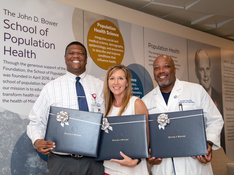The first graduates of the executive masters in population health management program in the School of Population Health are, from left, Dr. Demondes Haynes, Lorie Ramsey and Dr. Jermaine Gray.