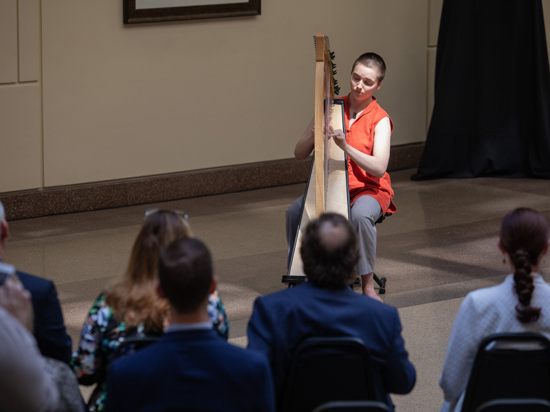 Harpist/vocalist Laura Pitts performs one of three musical selections.