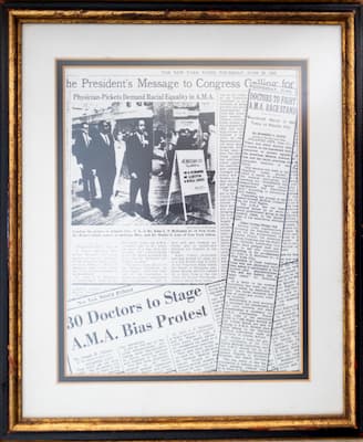 Dr. Robert Smith owns these framed newspaper clippings chronicling the efforts of physicians, including Smith, to break down racial barriers.