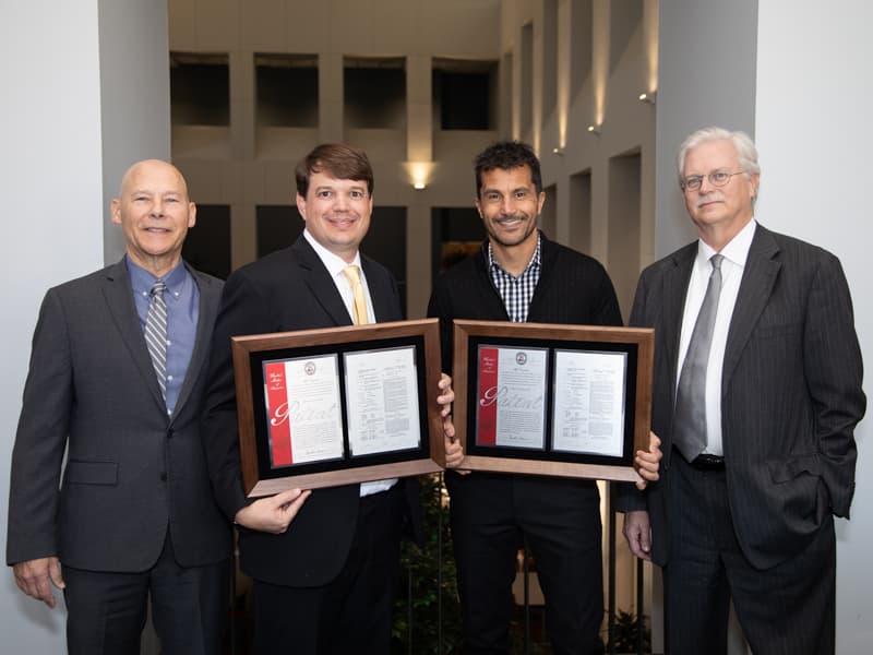 Inventors Bidwell and Dr. Alejandro R. Chade with their patent, "Kidney-Targeted Drug Delivery Systems" with Patell and Summers.