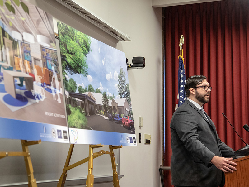 Dr. Christian Paine tells of the need for the planned pediatric skilled nursing facility, which is shown in the renderings beside him.
