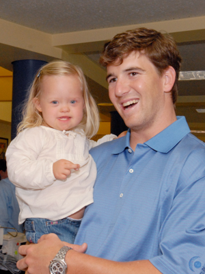 New York Giants quarterback Eli Manning is shown holding Aubrey Armstrong during a visit to Batson Children's Hospital in 2008.
