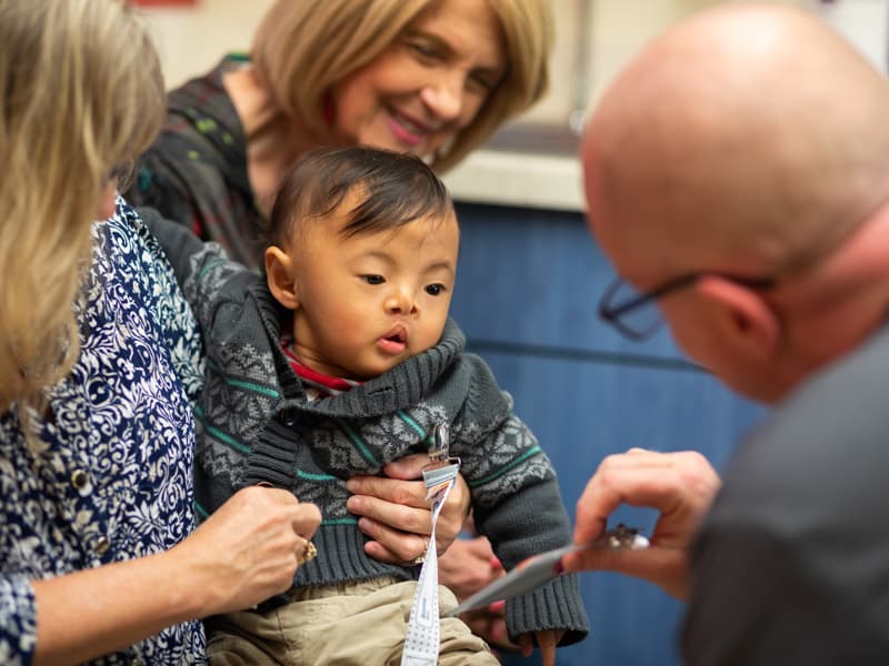 Scotty Virak looks at a nurses ID badge during a follow-up visit at Children's of Mississippi's Eli Manning Clinics for Children.