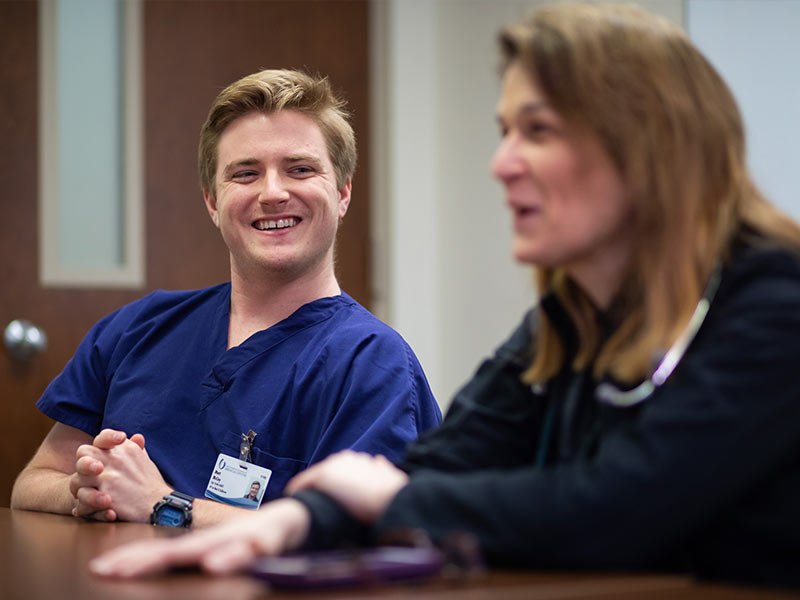 Medical scribe smiles at doctor.