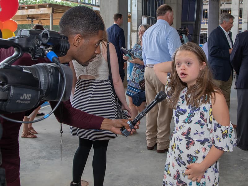 Marcus James of WJTV interviews Children's Miracle Network Hospitals Champion Aubrey Armstrong of Oxford before the start of the topping-out ceremony for Children's of Mississippi's expansion in June 2019.