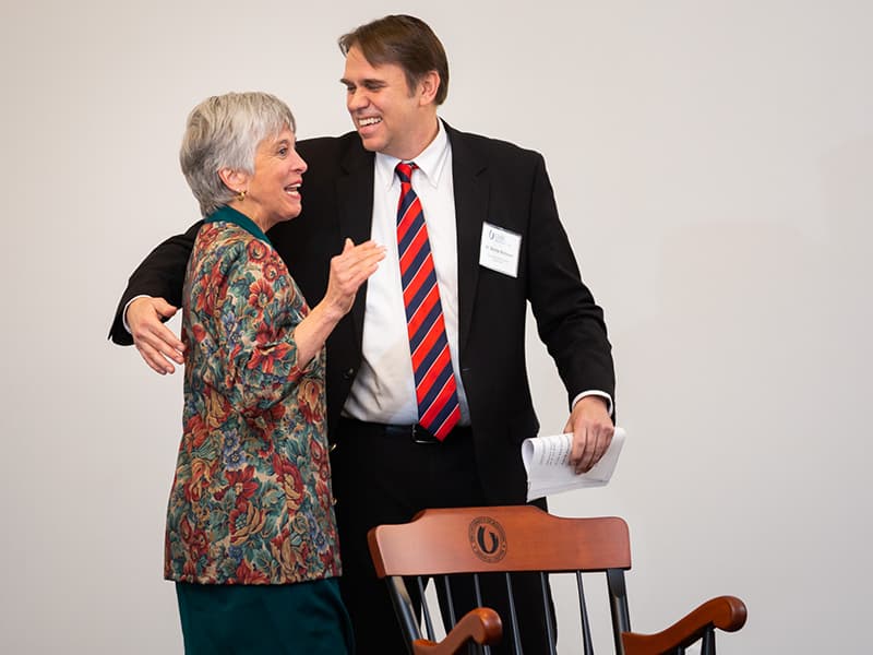 Dr. Barbara Mauldin hugs Dr. Kevin Holman.