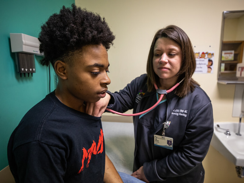 Nurse practitioner checks patients heartbeat.