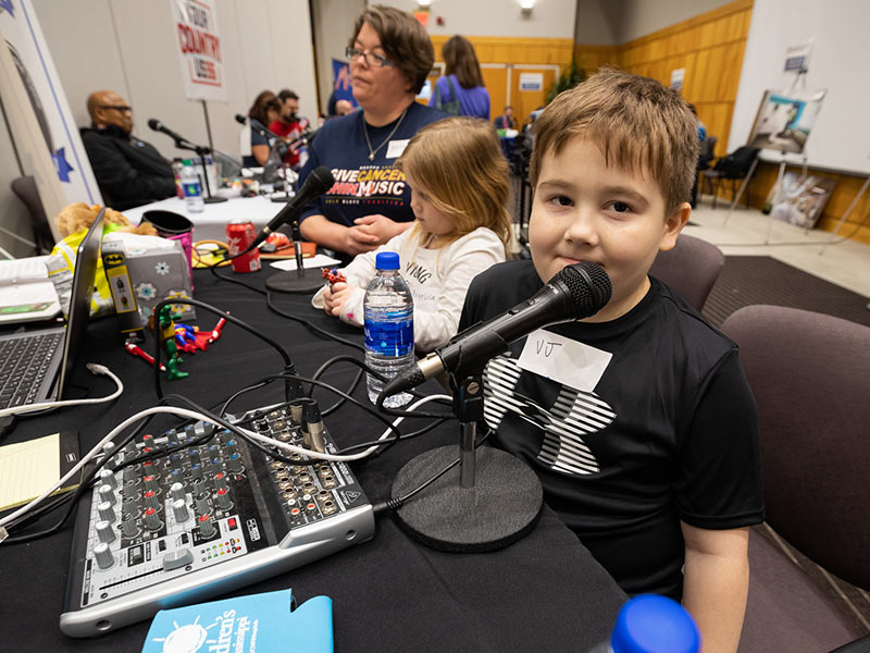 Children's of Mississippi patient VJ Worrell of Vicksburg is ready to broadcast. Beside him are mom Angel and sister Angelica.