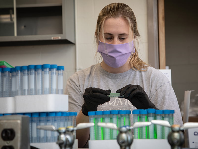 Erin McDevitt, a first-year medical student enrolled in the Disaster Management Course for students, assembles a COVID-19 test kit Friday at the Medical Center.