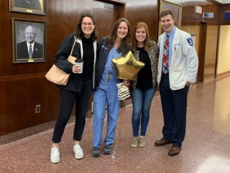 Gold Humanism inductee Wilson Helmhout, second from left, gets a three-fer tap, courtesy of, from left, Dr. Mary Moses Hitt, Dr. Melinda Talley and Dr. Austin Puckett.