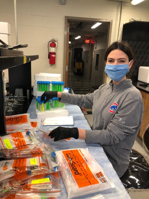 Wier volunteers in the Department of Microbiology and Immunology making test collection kits as part of the ongoing COVID-19 response.