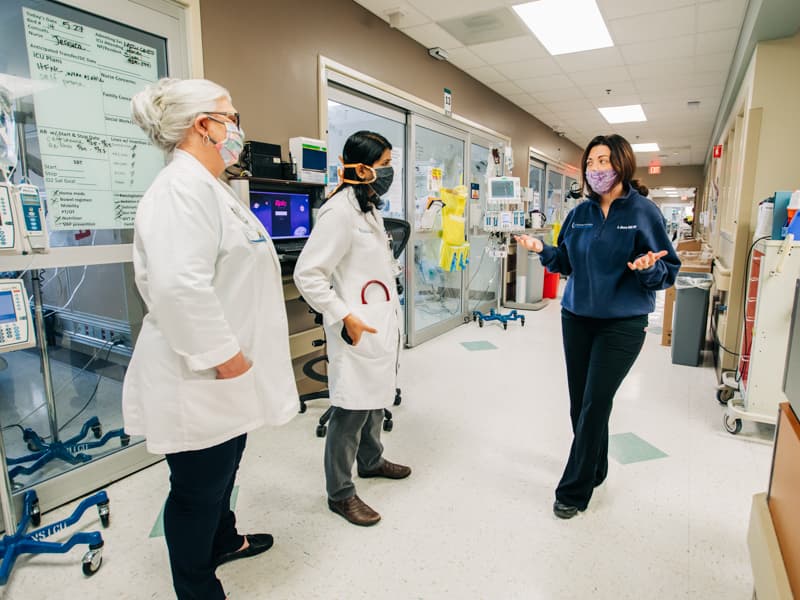 MICU nurse manager Ashley Moore, right, discusses COVID-19 patients with Sheila Fletcher, left, director of infection prevention; and Dr. Bhagyashri Navalkele, center, medical director of infection prevention and control.