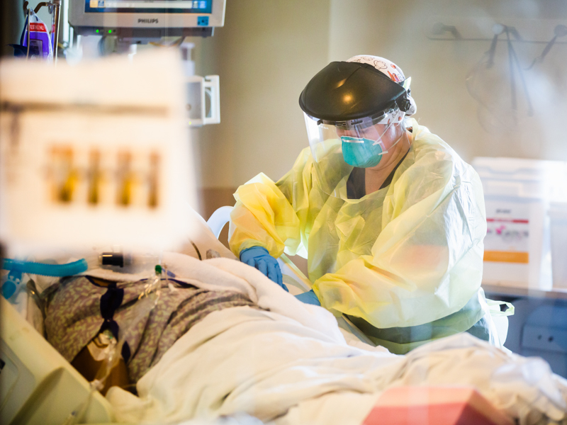 Allison Moore, medical ICU nurse, dons full personal protective equipment when she enters the rooms of COVID-19 patients.