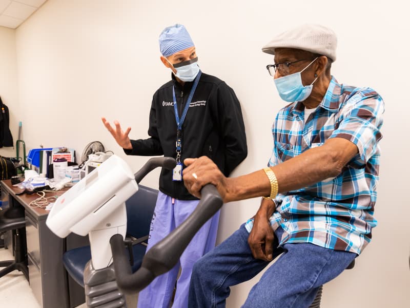 Dr. Michal Senitko, assistant professor of medicine and surgery and section division chief of interventional pulmonology, explains treatment options to lung cancer patient Sammie Bass of Jackson.