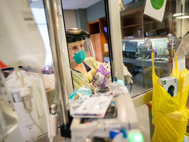 Registered nurse Allison Moore emerges from a COVID-19 patient room on the medical ICU. UMMC is joining a CDC-funded study on COVID-19 prevalence in communities.