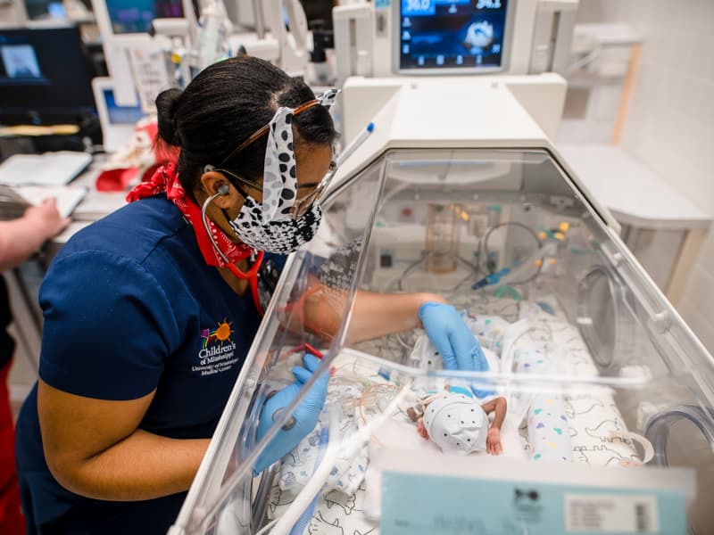 House officer Dr. Tasha Coleman checks Children's of Mississippi NICU patient (and fellow Dalmatian) Dallas Hughes of Hattiesburg.