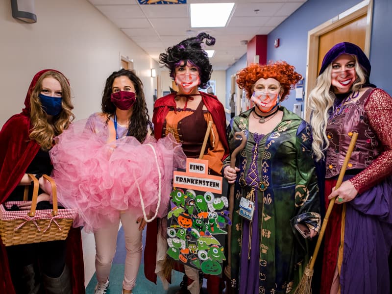 Reverse trick-or-treaters are, from left, Hannah Oliver as Little Red Riding Hood, Melissa Shields as a bath loofah, and Amy Lowery Carroll, Michelle Goreth and Amanda Hodges as the witches from the movie "Hocus Pocus."