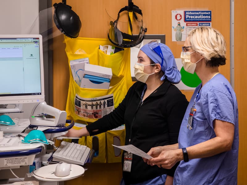 Registered nurses Amy Wigglesworth, left, and Kia Holly are among front-line caregivers for patients seen in the Clinical Research Trials Unit.