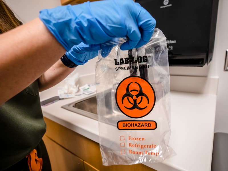 A laboratory technician at the Clinical Research Trials Unit safeguards specimens to be used in a trial.