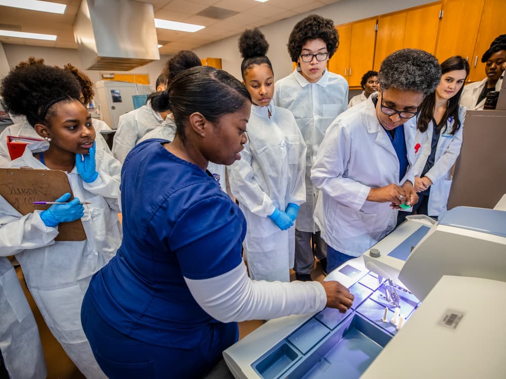  Demetrius Brown, HTL graduate, demonstrates how tissue biopsies are embedded.