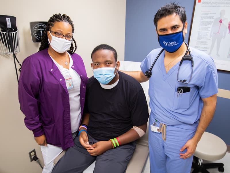 Celebrating Stewart's good health are, from left, Tonjula Shelby, a care coordinator in the Division of Cardiovascular Diseases, Stewart and Hernandez.