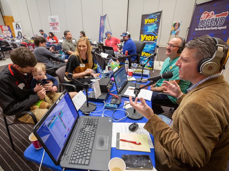 Cory, Ward and Abbey Phillips of Madison share their Children's of Mississippi story with Scott Steele, right, and Mark McCoy of 93.5 The Legend during the 2020 Mississippi Miracles Radiothon.