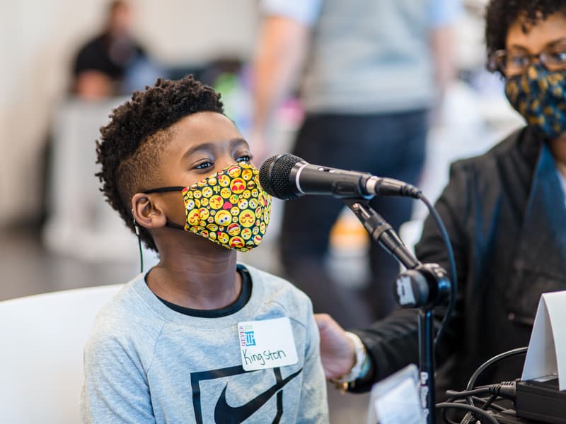 Kingston Murriel of Brandon, a Children's Heart Center patient, speaks into the microphone during the radiothon.