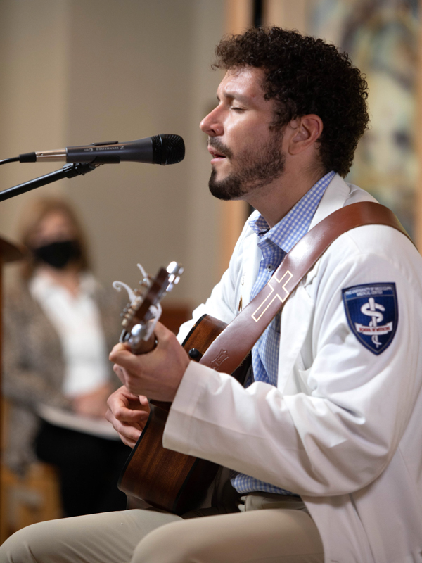 Conner Ball, a second-year UMMC medical student, sings "Amazing Grace" during a live stream ceremony of thanksgiving in memory of anatomical donors Tuesday, May 11, 2021.