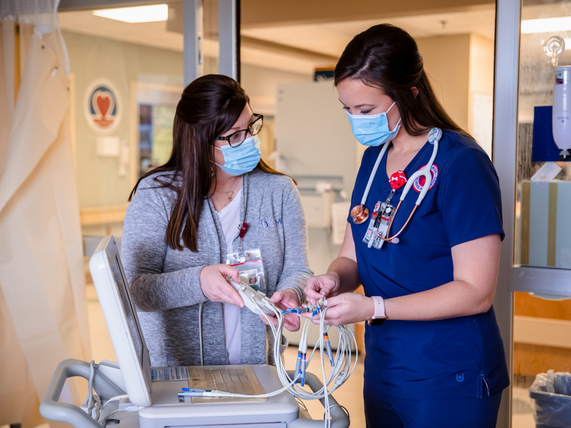 Cardiac Intensive Care Unit nurse educator Deanna Chambers discusses patient monitoring with future CICU nurse Makenzie Byrd.