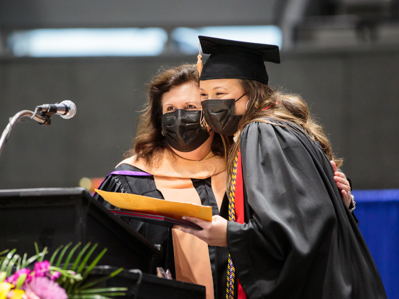 Dr. Julie Sanford, dean of the School of Nursing, presents the Christine L. Oglevee Memorial Award to Makenzie Byrd, baccalaureate graduate.