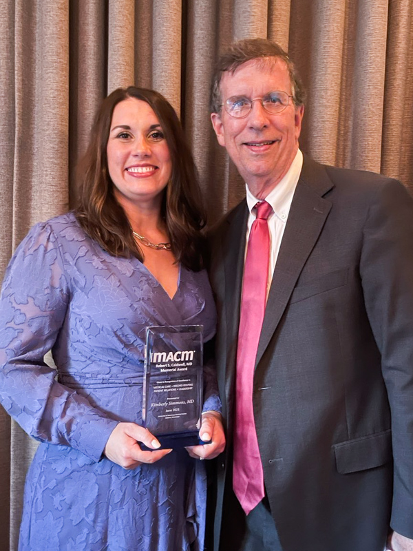 Dr. Marty Tucker, chair of ob-gyn, congratulates Dr. Kimberly Simmons, an ob-gyn fellow, for receiving the 2021 MACM Caldwell Award.