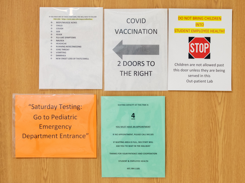 Signs of the times are seen on the door to Employee Health.