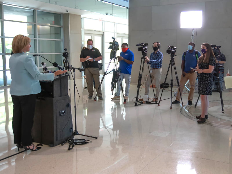 Dr. LouAnn Woodward, left, vice chancellor for health affairs and dean of the School of Medicine, speaks to media during a news conference Wednesday on the UMMC campus.