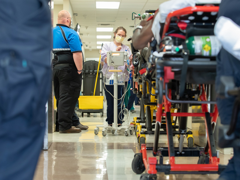 UMMC Emergency Department technician Abby Oliver takes the temperatures of patients waiting to be admitted.