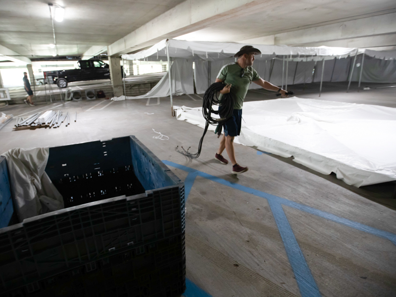 Sunbelt Rentals employee Jarrett England helps set up a field hospital in parking garage B August 11 on the UMMC campus.