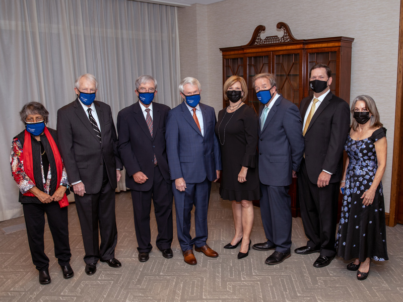 The 2021 honorees, with Dr. LouAnn Woodward, center, are, from left, Dr. Rathi Iyer, Dr. Kenneth Bennett, Dr. Owen "Bev" Evans, Dr. Joe Files, (Woodward), Dr. Bryan Barksdale, Dr. Shannon Orr and Dr. Susan Buttross.