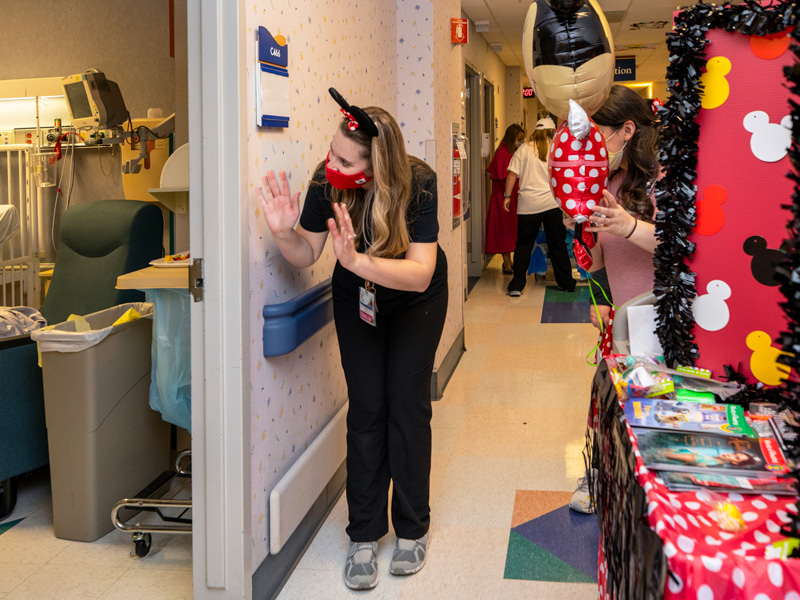 Child life specialist Madeline Wilson waves to a Children's of Mississippi patient during the hospital's Thanksgiving Parade Nov. 22.