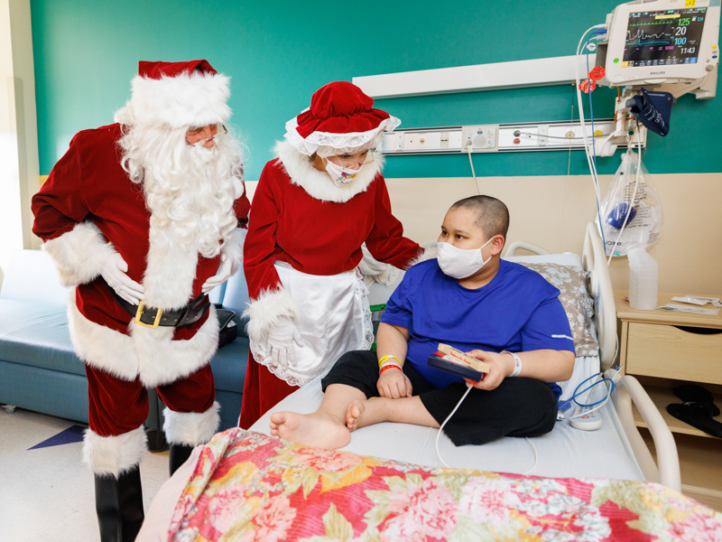 Santa and Mrs. Claus listen to the Christmas wishes of Collin Khong, a patient at Children's of Mississippi.