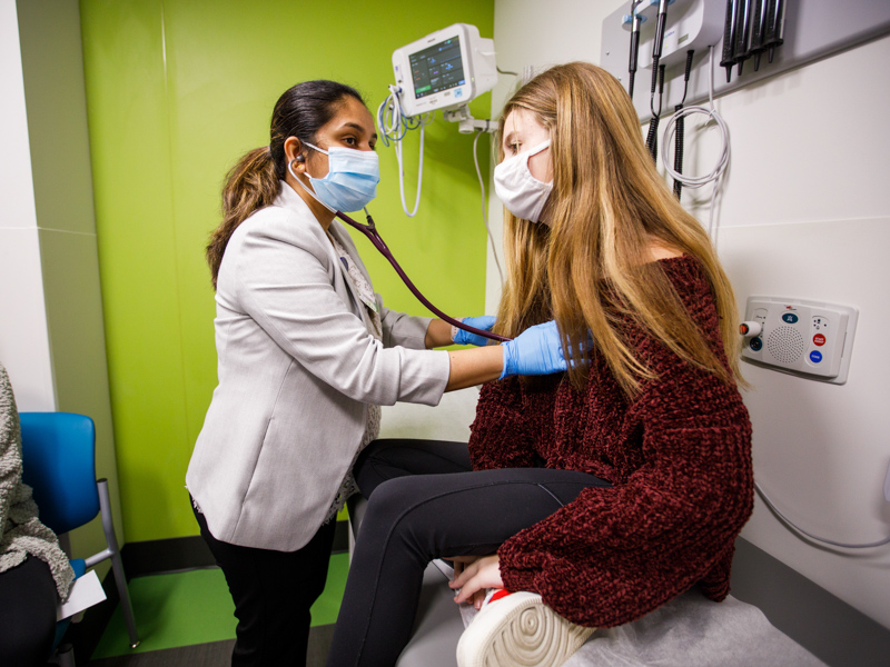 Cardiologist Dr. Jyothsna Akam-Venkata listens to Allie Henderson's heartbeat during an outpatient visit