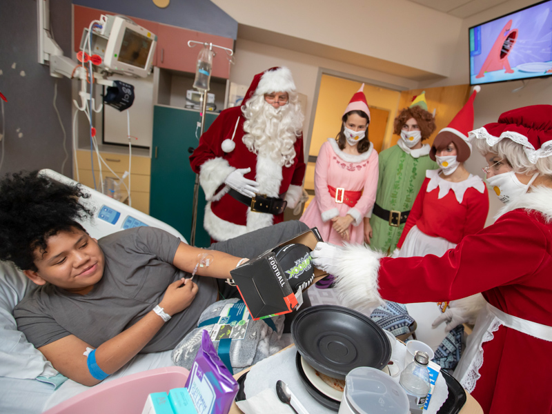 Children’s of Mississippi patient Favion Willard gets a visit from Santa and Mrs. Claus and the elf crew Wednesday.