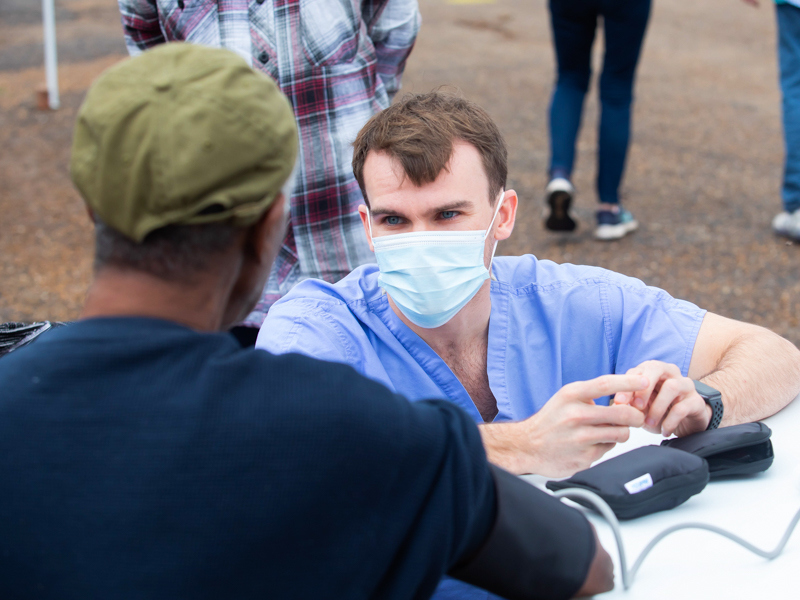 Joseph Cook, a Jackson Free Clinic medical student volunteer, asks Wilbert McGee some questions during a December 10 health screening event held in conjunction with Shower Power.