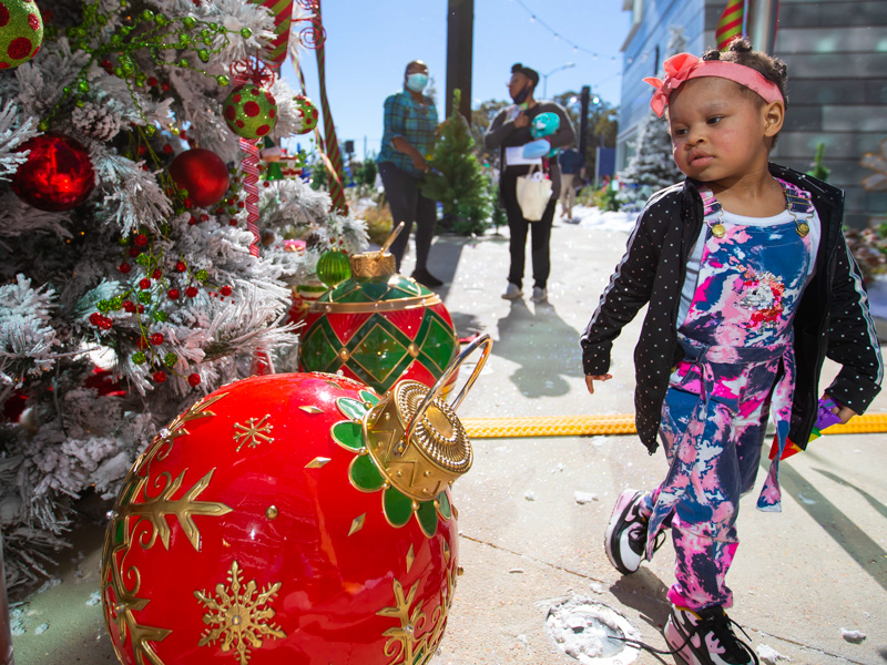 Children's of Mississippi patient Karleigh Matthews of Natchez takes in the holiday decorations at BankPlus Presents Winter Wonderland.