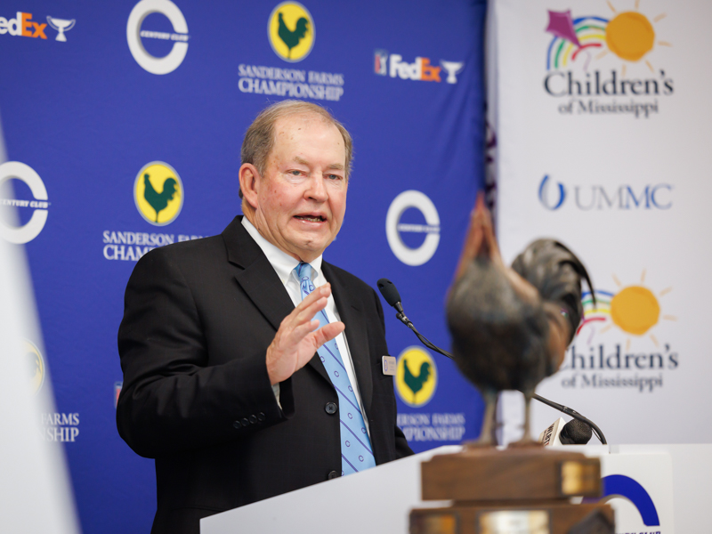 With Reveille, the Sanderson Farms Championship trophy, in the foreground, Pat Busby, president of Century Club Charities, announces a $1.5 million gift to benefit Children's of Mississippi.