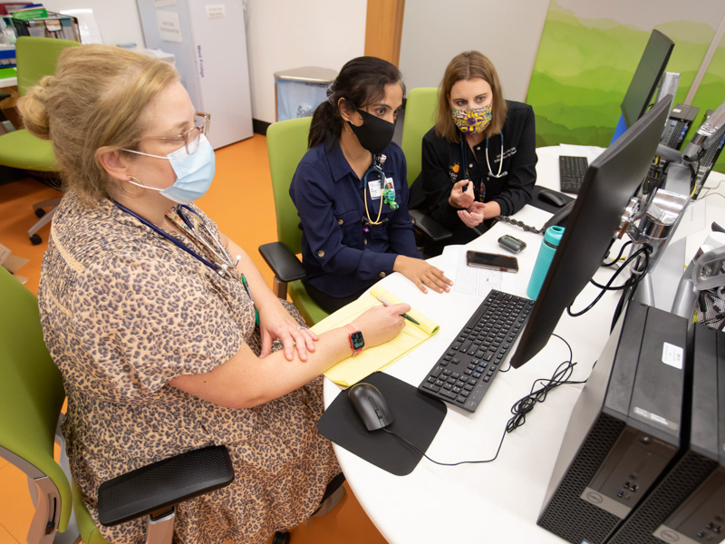 From left, Dr. Charlotte Hobbs, Dr. Anita Dhanrajani and Dr. Catherine Gordon discuss patient care at the collaborative MIS-C clinic in the Kathy and Joe Sanderson Tower at Children's of Mississippi.