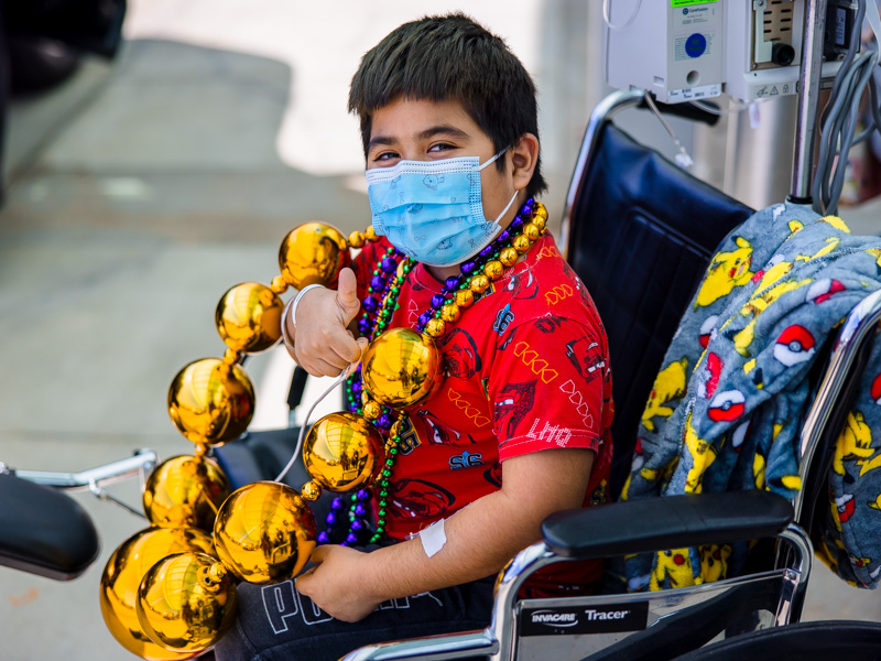 Children's of Mississippi patient Ashanti Evans of Lawrence gives the Mississippi Department of Public Safety's Mardi Gras parade a thumbs up.