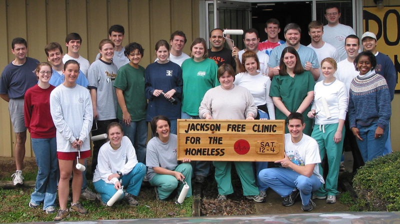 Dr. Joyce Olutade, far right, and medical students ready the JFC's new building in 2002. Among them, standing directly behind the sign, is the medical student version of Dr. Katie Taylor. (Photo courtesy of JFC/JoJo Dodd)