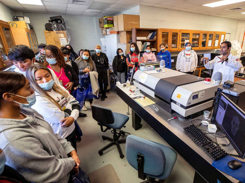 Dr. Kartikeya Jodha, right, a postdoctoral research fellow in the Biomedical Materials Science Department, gives the students the Reader's Digest summary of the processes used to make implants, crowns, bridges and more, in the School of Dentistry.