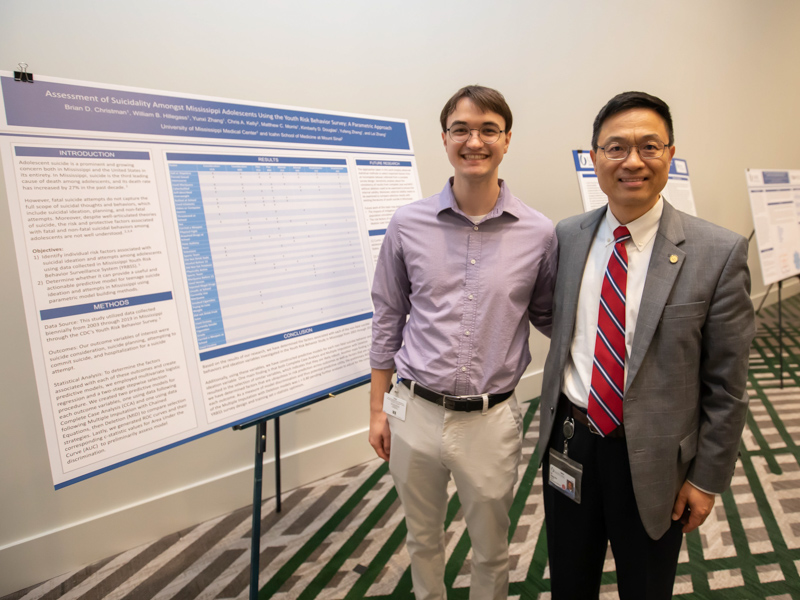 Nursing student Brian Christman smiles with School of Nursing Associate Dean for Research and Scholarship Dr. Lei Zhang.