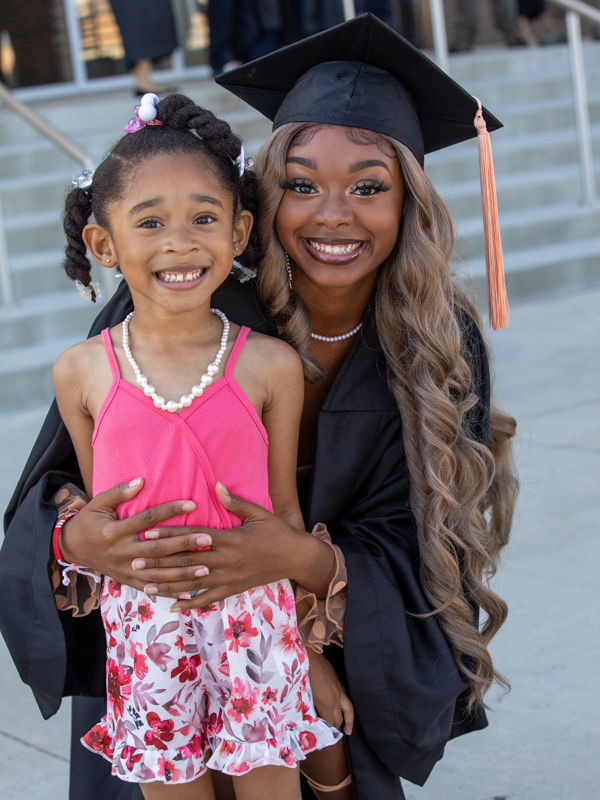 UMMC nursing graduate Adia Knighten of Southaven holds sister Abigail Tanksley, 4. Jay Ferchaud/ UMMC Communications