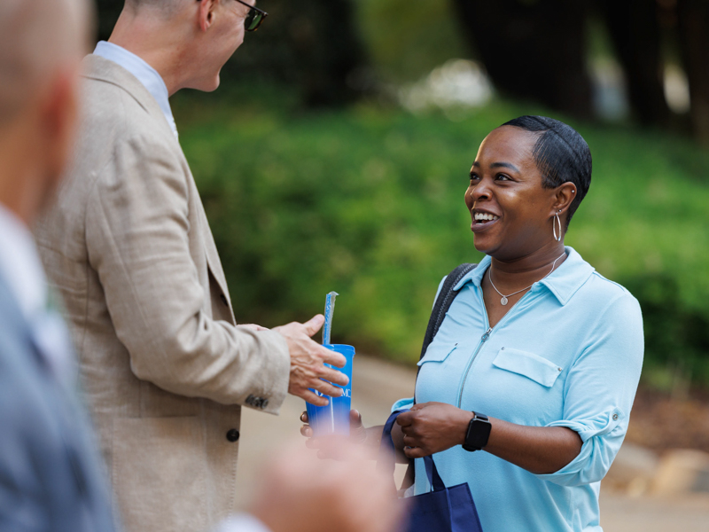 Executive assistant Sparkle Robinson receives a cup from Dr. Scott Rodgers Thursday during Employee Appreciation Week. Joe Ellis/ UMMC Communications 